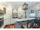 Well-appointed kitchen with white cabinetry, stainless steel appliances, and a granite-topped island with barstool seating at 10115 Mizner Ln, Raleigh, NC 27617