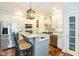 Bright, open kitchen with stainless steel appliances, white cabinets, and granite counters, ideal for cooking and entertaining at 10115 Mizner Ln, Raleigh, NC 27617