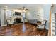 Inviting living room featuring a stone fireplace, hardwood floors, and ample seating for comfortable gatherings at 10115 Mizner Ln, Raleigh, NC 27617