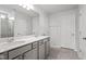 Bathroom with double sinks, large mirror and shower with neutral tile at 108 Grove Township Way, Angier, NC 27501