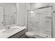 Modern bathroom with glass shower door and sink with gray cabinets at 108 Grove Township Way, Angier, NC 27501