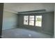Bright, unfinished bedroom with three large windows and tray ceiling at 108 Grove Township Way, Angier, NC 27501