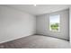 Bright bedroom with neutral carpet and a sun-filled window with views of the outdoors at 108 Grove Township Way, Angier, NC 27501