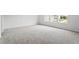Bright bedroom with neutral carpet and view of neighborhood through windows at 108 Grove Township Way, Angier, NC 27501