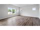 Bright bedroom with wood-look floors and ample natural light from large windows at 108 Grove Township Way, Angier, NC 27501