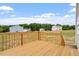 New wooden deck overlooking the backyard and new construction in neighborhood at 108 Grove Township Way, Angier, NC 27501