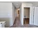 Hallway with carpet and access to a closet with shelving, with neutral paint and white trim at 108 Grove Township Way, Angier, NC 27501
