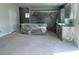 Spacious kitchen area featuring cabinetry and an island, all neatly wrapped in protective plastic at 108 Grove Township Way, Angier, NC 27501