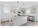 Open concept kitchen with granite island, pendant lighting, and stainless steel appliances at 108 Grove Township Way, Angier, NC 27501