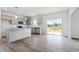 Open concept kitchen with stainless steel appliances, granite countertops, and access to the outdoor deck at 108 Grove Township Way, Angier, NC 27501