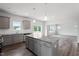 Open kitchen flows into the living area and features an island with stainless steel appliances at 108 Grove Township Way, Angier, NC 27501