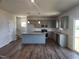 Open kitchen with granite countertops, stainless steel appliances, and wood flooring at 108 Grove Township Way, Angier, NC 27501