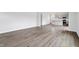 Open-concept living room with hardwood flooring that flows into kitchen area at 108 Grove Township Way, Angier, NC 27501