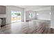 Bright open-concept living area featuring wood-look floors and sliding glass doors to the deck at 108 Grove Township Way, Angier, NC 27501