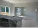 Open living area with sliding doors to a deck and windows that invite abundant light at 108 Grove Township Way, Angier, NC 27501