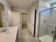 Main bathroom with tiled flooring, shower, and double vanity at 108 Grove Township Way, Angier, NC 27501