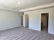 Main bedroom with carpet and view to main bathroom and walk in closet at 108 Grove Township Way, Angier, NC 27501