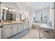 Elegant primary bathroom with dual vanities, granite countertops, and soaking tub at 1137 Fanning Dr, Wake Forest, NC 27587