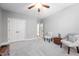 Bright bedroom with plush carpeting, ceiling fan and two cozy chairs at 1137 Fanning Dr, Wake Forest, NC 27587
