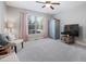 Bedroom featuring a large window, ceiling fan and grey armoire, providing ample space at 1137 Fanning Dr, Wake Forest, NC 27587