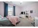 Comfortable bedroom with natural light, a full-length mirror, and ample closet space at 1137 Fanning Dr, Wake Forest, NC 27587