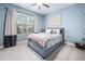 Cozy bedroom featuring blue walls, a comfortable bed, and a large window for natural light at 1137 Fanning Dr, Wake Forest, NC 27587