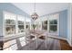 Light-filled breakfast nook with a view of the outdoors and a rustic modern light fixture at 1137 Fanning Dr, Wake Forest, NC 27587