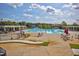 Spacious community pool area with lounge chairs, umbrellas, and a water slide for Gathering fun and relaxation at 1137 Fanning Dr, Wake Forest, NC 27587