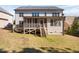 Rear view of home featuring deck, porch, and well-maintained lawn at 1137 Fanning Dr, Wake Forest, NC 27587