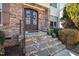 Charming front entryway featuring a stone facade, double doors with wreaths, and stone steps with iron railings at 1137 Fanning Dr, Wake Forest, NC 27587