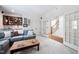 Living room featuring a large sectional sofa, wet bar, and a view of the staircase at 1137 Fanning Dr, Wake Forest, NC 27587