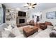 Cozy living room with a stone fireplace, built-in shelves, and comfortable seating arrangement at 1137 Fanning Dr, Wake Forest, NC 27587