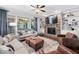 Comfortable living room with stone fireplace, hardwood floors, and plenty of natural light at 1137 Fanning Dr, Wake Forest, NC 27587