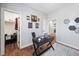 Bright home office featuring modern desk, motivational decor, and access to a walk-in closet at 1137 Fanning Dr, Wake Forest, NC 27587
