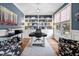 Stylish home office with custom built-in shelving, hardwood floors, and a large window for natural light at 1137 Fanning Dr, Wake Forest, NC 27587