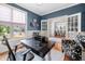 Well-lit home office with hardwood floors, french doors, built-in shelves, and a view of the outdoors at 1137 Fanning Dr, Wake Forest, NC 27587
