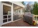Covered porch featuring wooden railing and outdoor cooking setup at 1137 Fanning Dr, Wake Forest, NC 27587