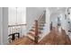 Elegant staircase featuring wooden steps, an iron railing, and natural light at 1137 Fanning Dr, Wake Forest, NC 27587