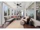 Inviting sunroom with comfortable seating, string lights, and a view of the wooded backyard at 1137 Fanning Dr, Wake Forest, NC 27587