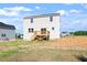 Exterior view of backyard with a wooden deck on a two-story home on a partly cloudy day at 119 Grove Township Way, Angier, NC 27501