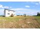 Landscape view of a home and large backyard with ample space and clear blue skies at 119 Grove Township Way, Angier, NC 27501