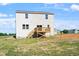 Exterior view of the backyard with a wood deck of a two-story home with vinyl siding at 119 Grove Township Way, Angier, NC 27501