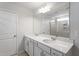 Bright bathroom featuring a double vanity with quartz countertops and large mirror at 119 Grove Township Way, Angier, NC 27501