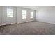 Spacious bedroom featuring three bright windows and neutral carpeting at 119 Grove Township Way, Angier, NC 27501
