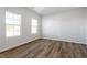 Bedroom with laminate flooring, white walls, and natural light from two windows at 119 Grove Township Way, Angier, NC 27501