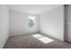 An empty bedroom with neutral carpet, paint, and trim at 119 Grove Township Way, Angier, NC 27501