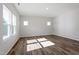 Light-filled bedroom features large windows, hardwood floors, and ample natural light at 119 Grove Township Way, Angier, NC 27501