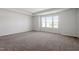 An empty bedroom with neutral colored carpet, paint, and trim at 119 Grove Township Way, Angier, NC 27501