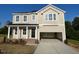 Charming two-story home with an attached two-car garage and inviting front porch at 119 Grove Township Way, Angier, NC 27501