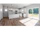 Modern kitchen with island, white cabinets, stainless appliances, and seamless transition to outdoor deck at 119 Grove Township Way, Angier, NC 27501